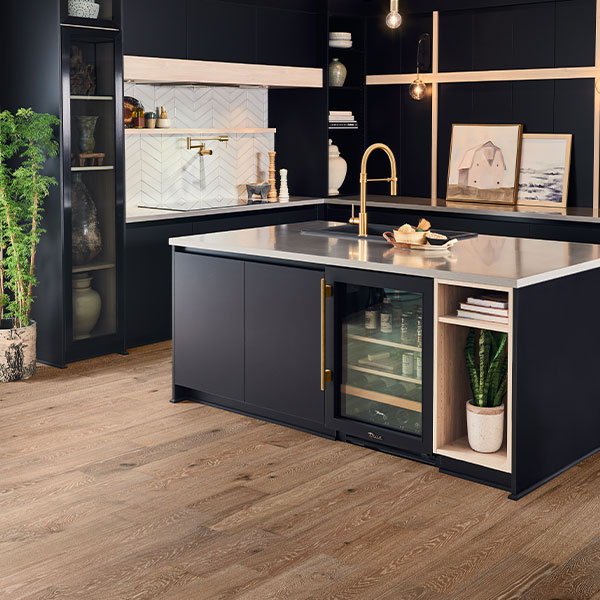 hardwood flooring in kitchen with navy blue cabinets and modern decor